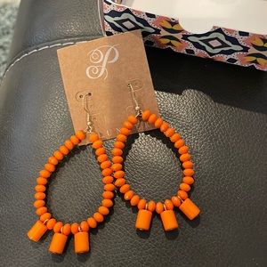 Brand new orange Plunder earrings